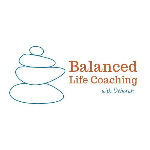 blue rocks balanced on top of each other with the words balanced life coaching to the right of it