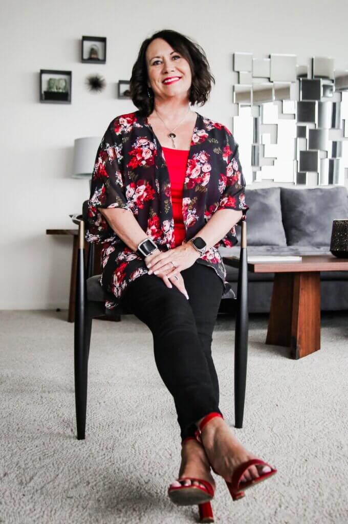 woman sitting in chair with red shoes. Life coach.